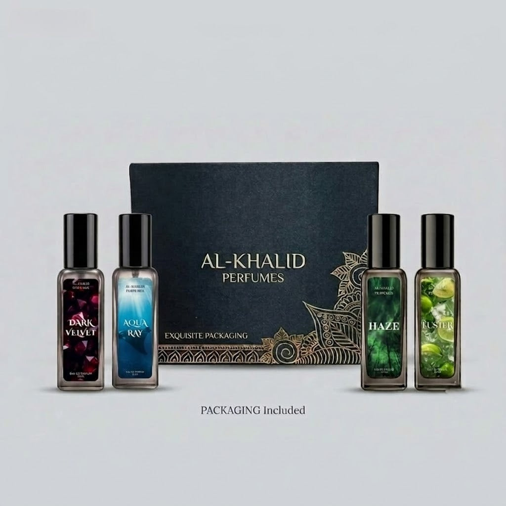 A set of five Al-Khalid Perfumes bottles arranged in front of a black branded box with gold detailing on a light gray background. The set includes Dark Velvet, Aqua Ray, Haze, and Oasis scents, with the text 'PACKAGING Included' below.