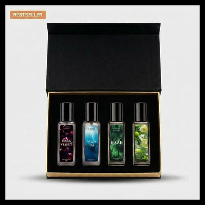 A boxed set of four small fragrance oil bottles displayed inside an open black presentation box with a gold trim. The set includes scents labeled Rosemary Mint, Aqua Ray, Haze, and Lime.
