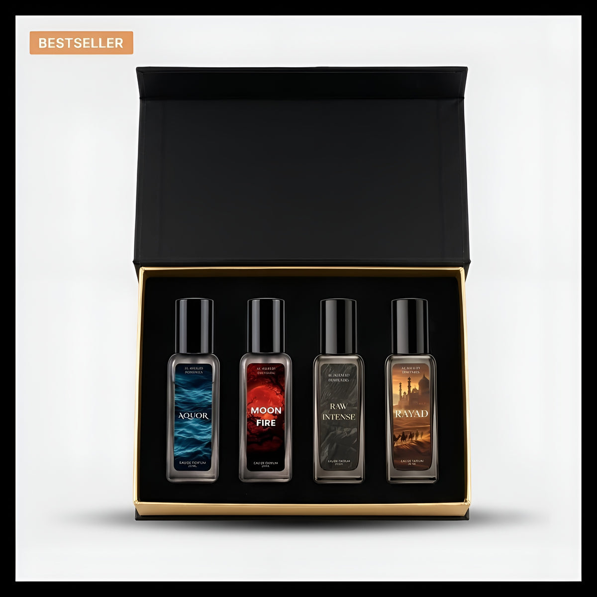 A boxed set of four fragrance oil bottles presented in an open black gift box with a gold inner trim, on a light gray background. The bottles have black caps and dark glass, with labels in blue, red, gray, and brown tones.