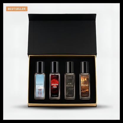 A boxed set of four small fragrance bottles displayed inside an open black gift box with a gold inner trim, on a light gray background. The set includes Bleu Mont, Moon Fire, R.