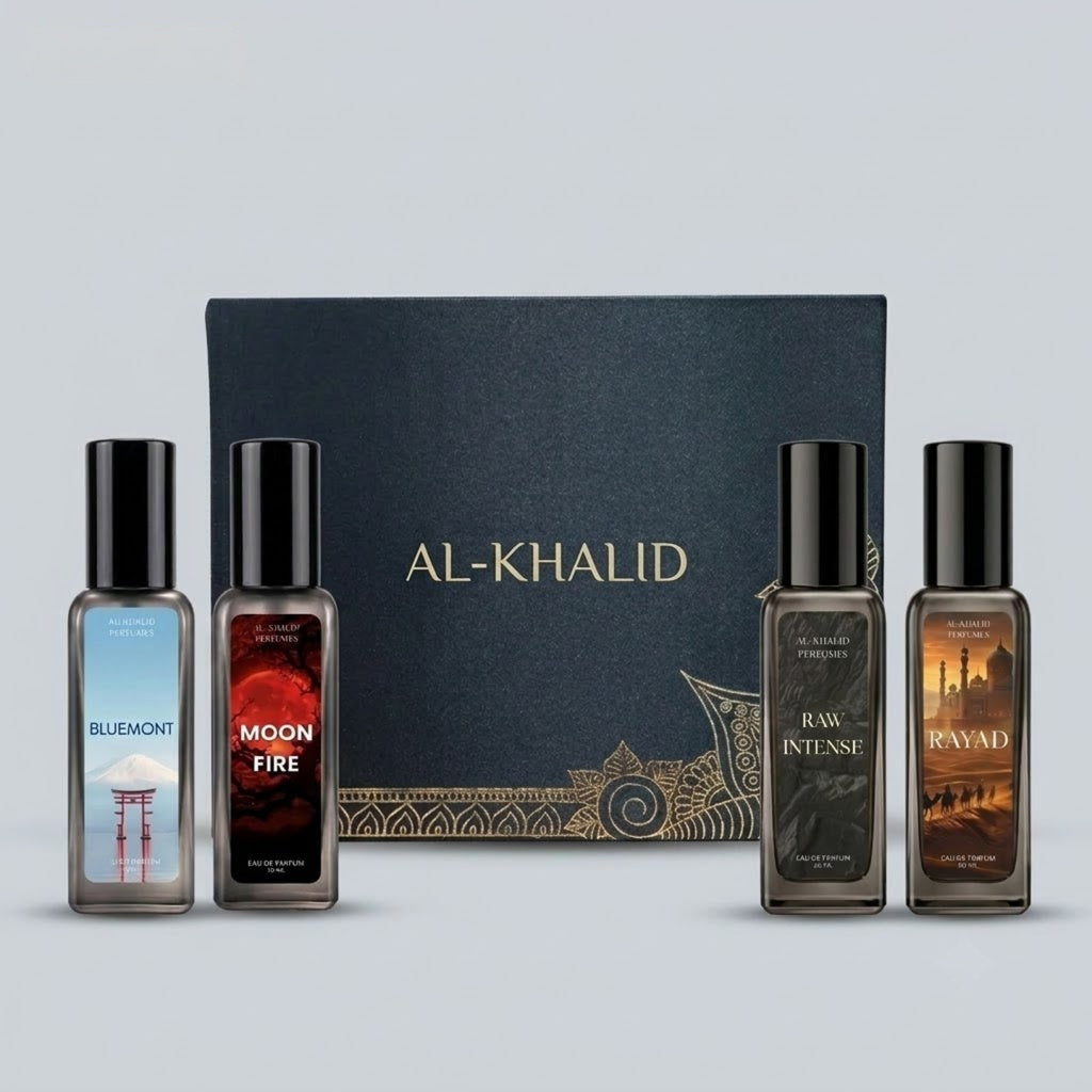 A perfume gift set featuring four Al-Khalid fragrance bottles in front of a dark blue presentation box. The bottles are labeled Bluemont, Moon Fire, Raw Intense, and Ravad, with black caps and decorative gold patterns on the box.